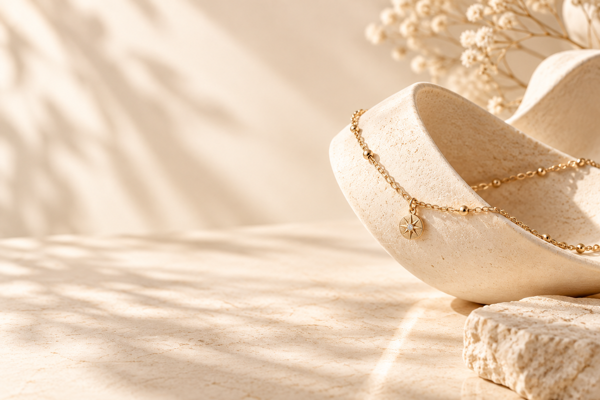 Soft AURYN necklace still life on sculptural ivory ceramic