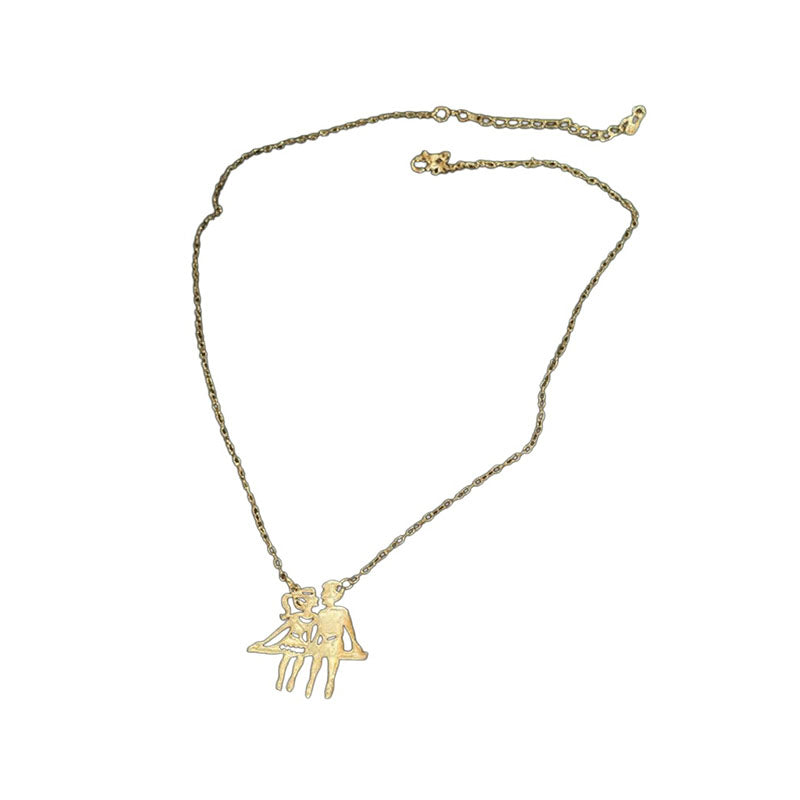 Gold-tone couple pendant necklace on white background