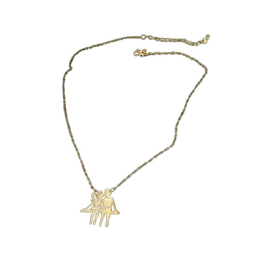 Gold-tone couple pendant necklace on white background