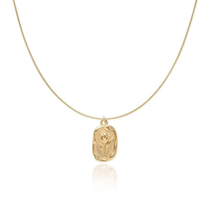 Gold-tone tulip pendant snake chain necklace on a white background
