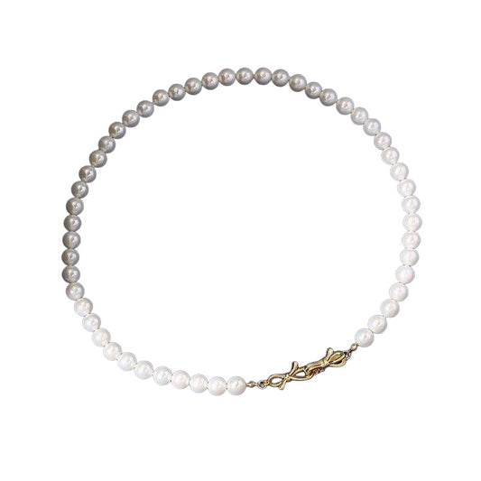 White 8 mm beaded necklace on white background