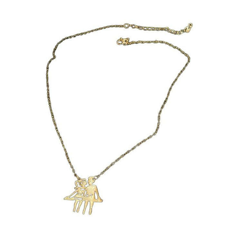 Gold-tone couple pendant necklace on white background