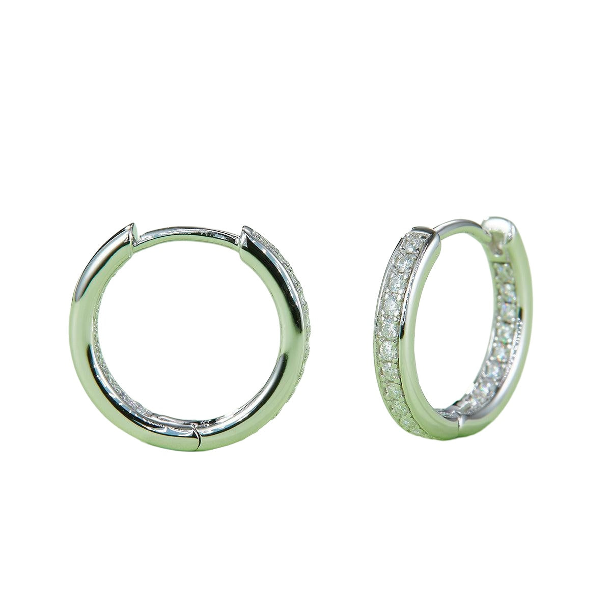 Moissanite huggie hoop earrings in platinum tone on white background