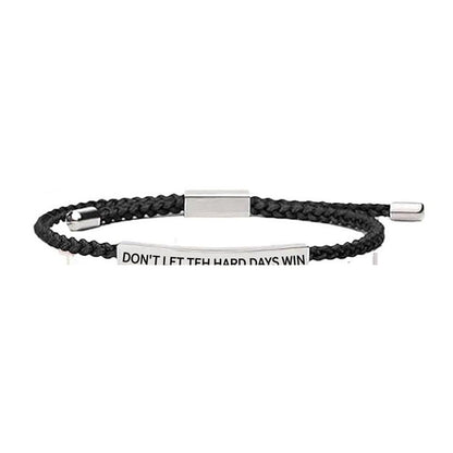 Black woven engraved bracelet on white background